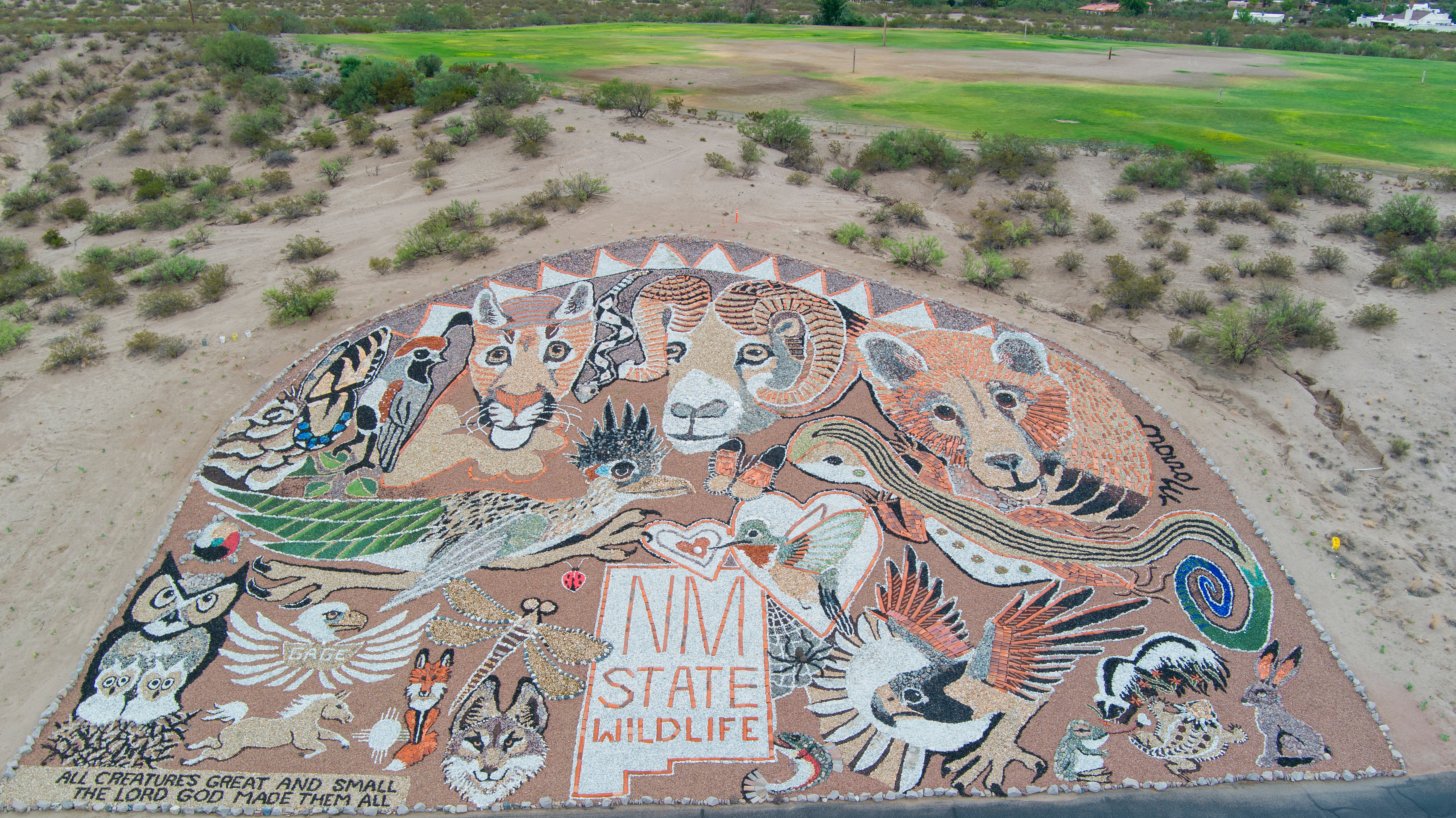 Mosaic mural representing New Mexico wildlife, featuring various animals and the text "NM State Wildlife."